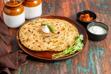 Methi paratha is a savory Indian flatbread made with fenugreek leaves, whole wheat flour, spices, and ghee, offering a flavorful, aromatic, and nutritious meal.