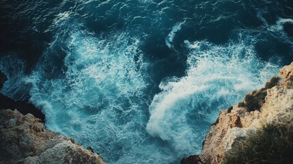 Waves gently crashing against a rocky coastline in soft blue tones