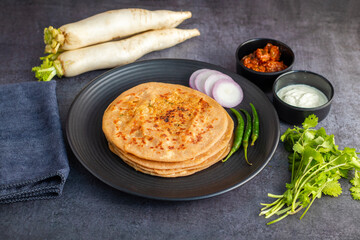 Mooli paratha is a stuffed Indian flatbread made with grated radish, whole wheat flour, and spices, offering a flavorful, nutritious, and wholesome meal.