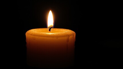 Candlelight flickering gently in a dark, peaceful room
