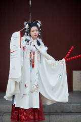 Asian girl wearing Ming Dynasty Hanfu outdoors after heavy snow