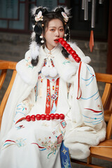 Asian girl wearing Ming Dynasty Hanfu outdoors after heavy snow