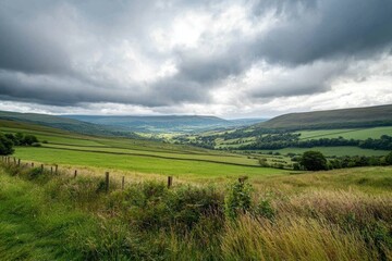 Fototapeta premium Scenic Green Valley Landscape Under a Cloudy Sky in the Countryside During Late Afternoon Hours