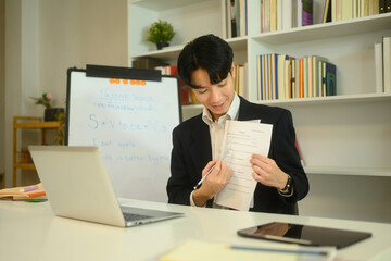 Smiling tutor explaining a worksheet to student during an online learning session