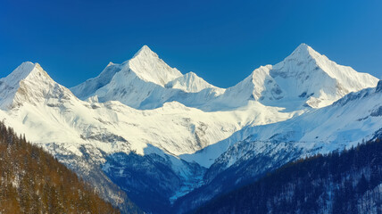 Fototapeta premium Majestic snow-capped mountains under a clear sky