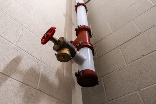 looking up view of fire hose standpipe system strategy in stairwell with concrete wall background fire safety efficiency awareness	
