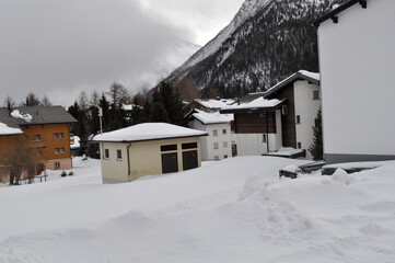 A snowy mountain in the background of village houses in the winter months. A perfect place to relax in the winter. Winter tourism.