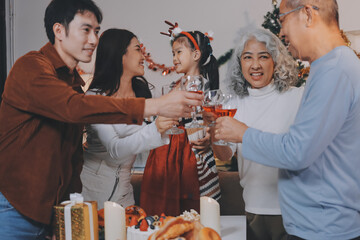 Merry Christmas! Happy family are having dinner at home. Celebration holiday and togetherness near tree.