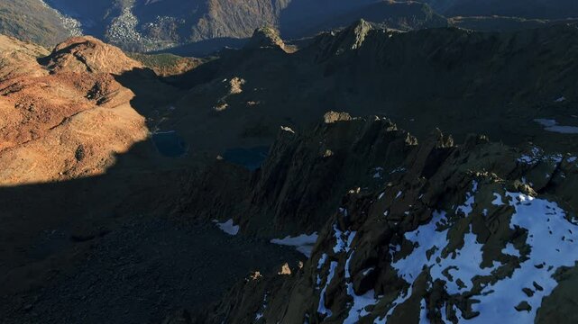 Predaccio, Valmalenco, Lombardy, Italy - Snow-capped Peaks Tower Above a Turquoise Lake, Which Sparkles Amidst the Rugged, Rocky Landscape Below - Aerial Drone Shot