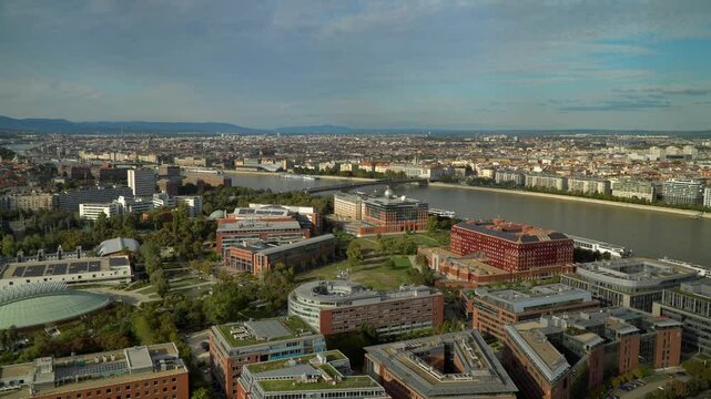 The flat skyline of Pest along the River Danube as seen from south Buda through the university buildings in Budapest, Hungary.