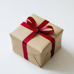 Obraz premium small gift box wrapped in red ribbon on white background, perfect for celebrations