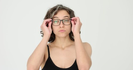 Beautiful woman thinking and putting on glasses