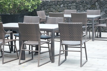 rattan and wooden chair table set. natural tropical style terrace. a place to relax.