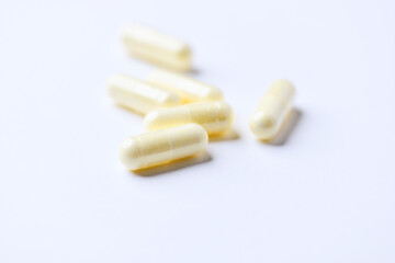 Alpha-lipoic acid capsules. Paper background. Soft focus. Close up. Copy space.