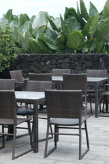 rattan and wooden chair table set. natural tropical style terrace. a place to relax.