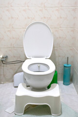 White flush toilet. Toilet bowl in restroom. Vertical photo. No people, nobody. Hygiene, excretory system idea concept.