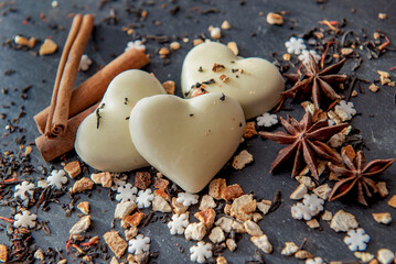 top view on heart-shaped cookies  and spices  arranged on a grey slate background