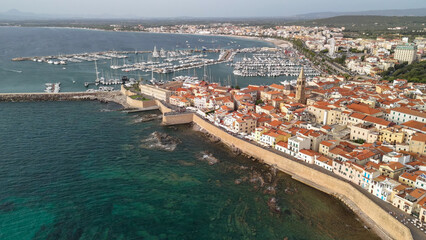 Scenic drone view of Alghero's coastline and historic town during a bright summer day