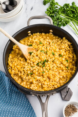 Steaming Parmesan ditalini soup in a pot, topped with grated cheese
