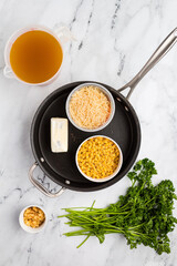 Ingredients for Parmesan pasta soup laid out, ready for preparation