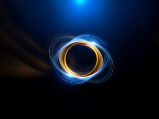Abstract image of glowing, elliptical rings.  The inner ring is gold, the outer, blue.  The background is dark blue, creating a cosmic feel.
