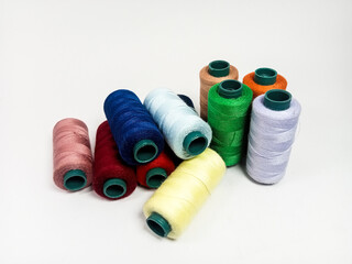 nylon sewing thread in roll form, various colors of sewing thread isolated on white background, suitable for textile industry product catalog design