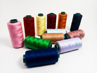 nylon sewing thread in roll form, various colors of sewing thread isolated on white background, suitable for textile industry product catalog design