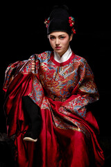 Young woman wearing Ming Dynasty Feiyu clothing on black background