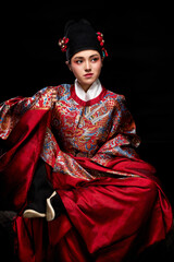 Young woman wearing Ming Dynasty Feiyu clothing on black background