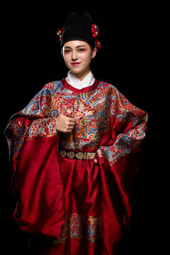 Young woman wearing Ming Dynasty Feiyu clothing on black background