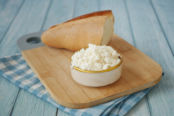Delicious Fresh Cottage Cheese Accompanied by Bread on a Wooden Board