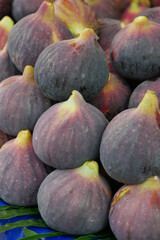Fresh, succulent figs beautifully displayed alongside vibrant green leaves for decoration