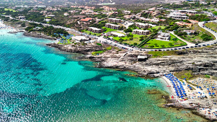 Stunning drone shot of La Pelosa Beach and historic Torre della Pelosa in Sardinia