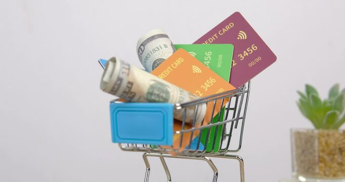 100 dollar bills in the shopping basket. close-up, spinning. Concept of finance, business, digital money. Shopping cart loaded with usd 100 bills spinning on white background.