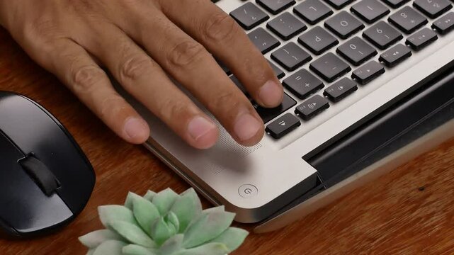 Motion close up finger click delete button. Concept of digital and delete from storage. The index finger presses the delete key on the laptop keyboard.