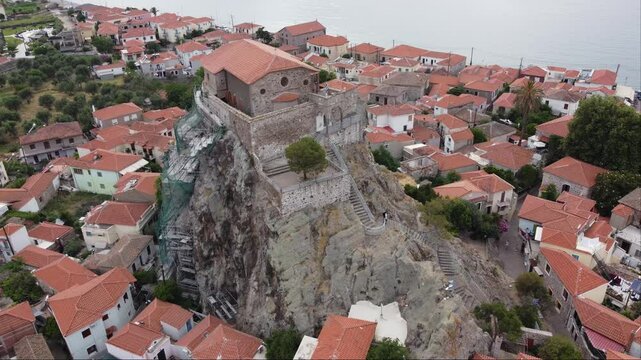 Aerial of restoration and repair of Virgin Mary greek orthodox church rock structure in Petra village, Lesbos, Aegean sea