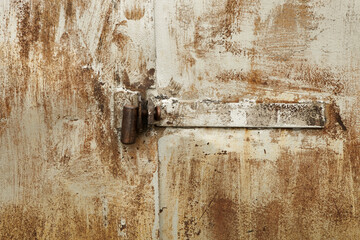 Old rusty padlock on the metal door