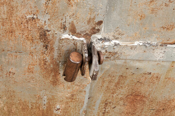 Old rusty padlock on the metal door