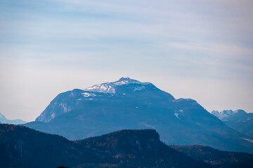 Panoramic view of majestic snow capped mountain summit Dobratsch, Gailtal Alps. Looking from Rosental, Carinthia, Austria. Alpine landscape surrounded by forest. Peaceful scene in remote Austrian Alps