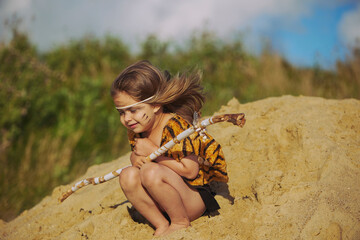 Cute baby dressed in the clothes of primitive people