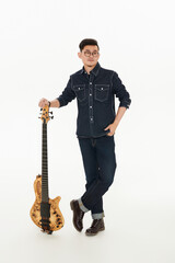 Naklejka premium Asian male musician holding bass guitar