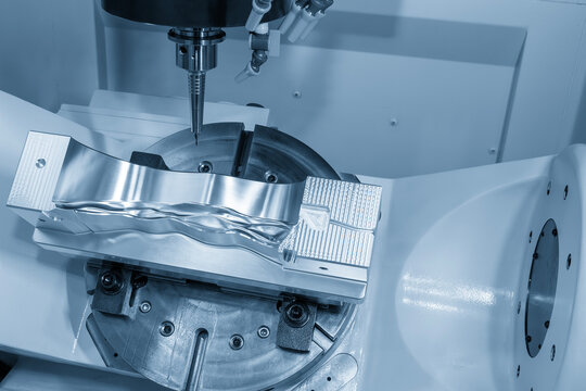 The 5-axis CNC milling machine  cutting the automotive part with solid ball end mill tool in the light blue scene.