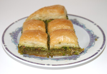 Delicious Turkish Pistachio Baklavas on Plate isolated on white