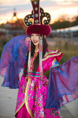 Obraz premium Mongolian girl wearing gorgeous traditional costumes of Mongolian tribe
