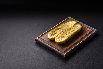 Delicious zucchini cut into two halves baked with salt, spices and herbs