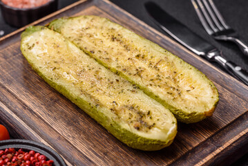 Delicious zucchini cut into two halves baked with salt, spices and herbs