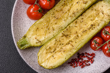 Delicious zucchini cut into two halves baked with salt, spices and herbs