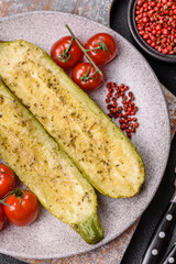 Delicious zucchini cut into two halves baked with salt, spices and herbs