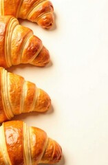 Croissants are arranged in a circle on a white background