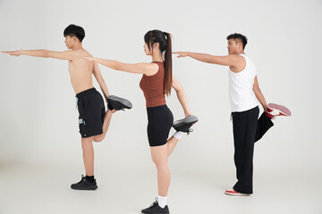 Obraz premium Two young men doing aerobics under the guidance of a beautiful coach